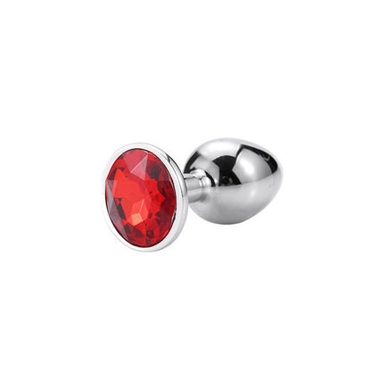 A red crystal anal plug with a metallic base and a tapered tip, featuring an imitation diamond design.