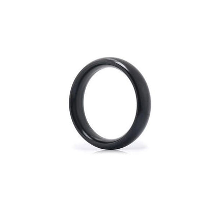 A metallic black, donut-shaped cock ring made from stainless steel, with a smooth and polished finish.