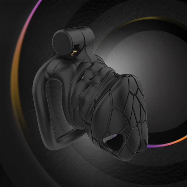 A black chastity cage with a cobra-inspired texture and a small size, displayed against a dark background with colorful light effects.