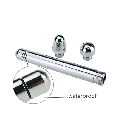 The image shows a silver-colored douche kit with three different-shaped tips, indicating various options for anal or vaginal cleansing. The product appears to be made of aluminium and is designed to connect to a shower hose for water pressure.