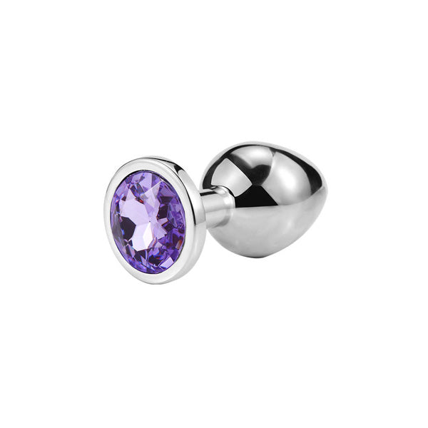 A lavender-colored anal plug with a shiny, tapered tip and a flared base. The plug is adorned with a diamond-like decoration on the front.