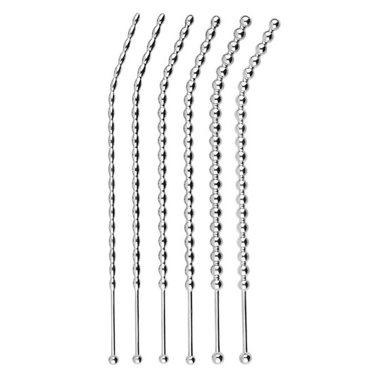 Set of urethral sounds on a white background